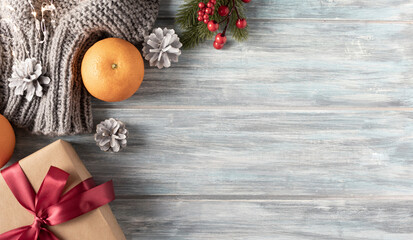 Christmas gift box, food decor and fir tree branch on wooden table. Top view with copy space