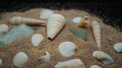 seashells Beautyful decoration with background of colorful small rocks, clay pot, class sand keepers and small magic portions 