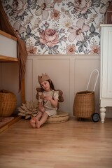 little girl sitting in a beautiful children's room
