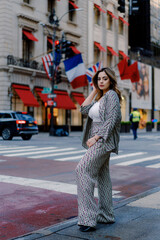 Woman walking in urban city street wearing stylish checkered suit