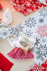 Handmade angel doll with red and white patterned fabric. Symbolizing cultural traditions, heirloom craftsmanship, and meaningful holiday gifting.