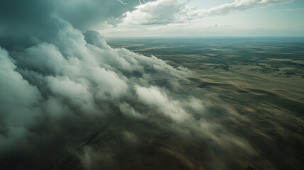 Obraz premium A dynamic aerial image of a thunderstorm rolling over a vast prairie with lightning illuminating the clouds.