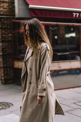 Chic Street Fashion Stylish Model Strutting in Trendy Trench Coat on the Streets