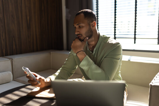 Businessman using laptop computer and smartphone for working online