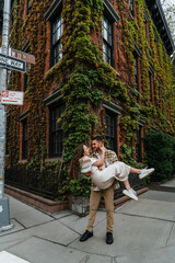 Romantic Moment: Couple Dancing on Sidewalk Near Ivy-Covered Building