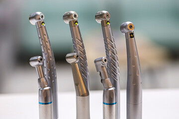 Dental hand instruments used in dental treatments. A rotary handpiece fitted with a bur, used to cut and abrade enamel tissue. Tooth decay and root canal treatment.  © UniqDream