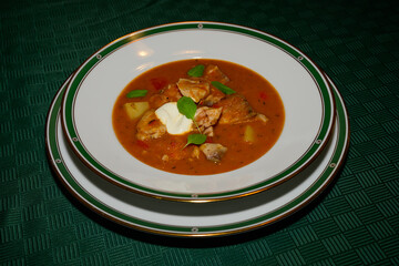 Pannonian Fish Goulash or Carp Porkolt with Sour Cream, Potatoes and Red Pepper Garnished with Marjoram