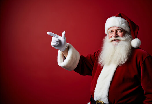 Happy Santa Claus pointing to the left side on a Red Background for Christmas Joy