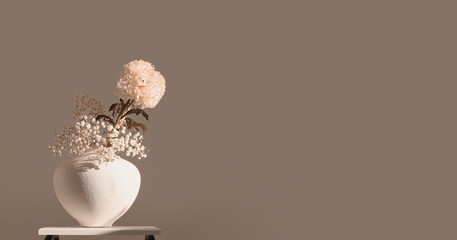 Smoke pink Beige chrysanthemums and gypsophila  flower in vase. Minimalist still life. Light and...