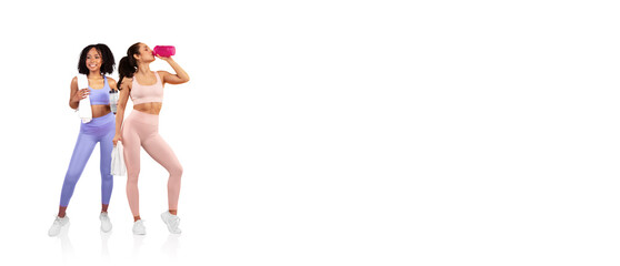 Two women in stylish workout clothing are engaged in fitness activities. One is hydrated with a...