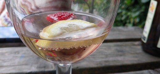 Drink with ice lemon raspberry and bubbles