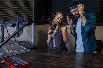 Hipster man and woman playback singers recording track