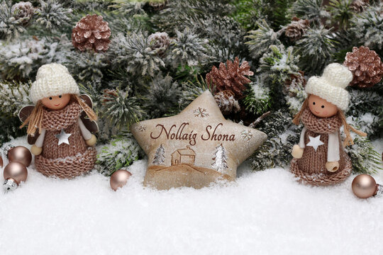 Christmas card: Christmas balls with fir branches and Christmas decorations in the snow with the Scottish text Nollaig Shona.