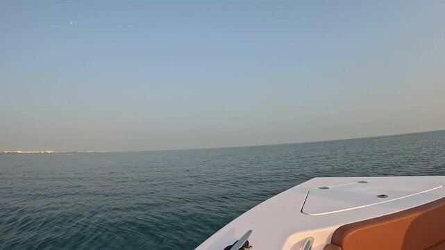 Tranquil view from a boat, where the calm sea meets an endless horizon under a soft, muted sky at Bant