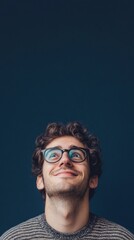 Obraz premium nerdy man with glasses smiling at camera on dark blue background with copy space vertically 9:16