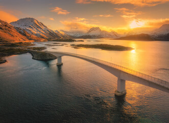 Scenic aerial view of fredvang bridges at colorful sunset in winter. Islands in lofoten...