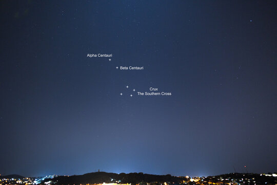 A real night scene over the city Windhoek, Namibia with starry sky showing constellation of Southern Crus and Alpha Centauri and Beta Centauri - Month July in Southern sphere