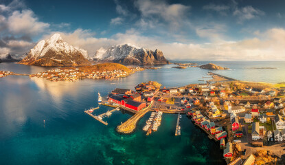 Panoramic aerial view of Reine fishing village with red rorbu houses at sunrise. Winter in Lofoten...