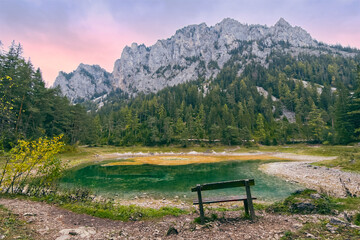 Grüner See at sunset, lake in Styria, Austria village  Tragöß.  Hochschwab Mountains and forests. Landscape and nature background
