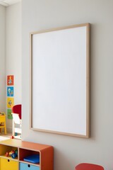 White framed picture hangs on a wall in a room with a lot of toys