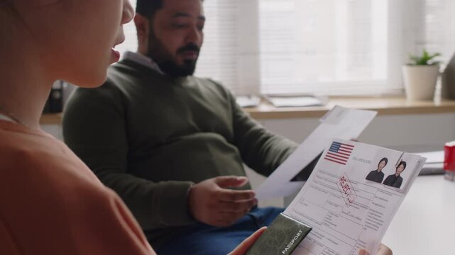 Side tilt shot of diverse husband and wife getting US visas rejected, they looking upset while discussing failed interview in embassy