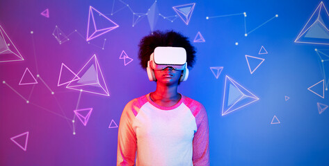 African girl with VR glasses standing at blue and pink background and looking at floating geometric shape. Excited person searching and entering visual reality world. Technology innovation. Ingenuity.