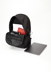 backpack with laptop and notebooks for studying on a white background