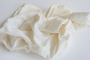 Obraz premium A close-up shot of a white cloth on a table, ideal for use in still life photography, product design, or as a background element