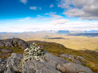 Stunning nature scene in Connemara, Ireland, county Galway. Country area with green hills, mountains and cloudy blue sky. Popular hiking area and tourist spot. Amazing Irish nature view.
