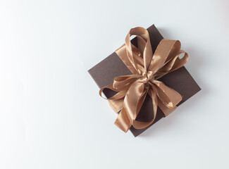 brown gift box with a mocha mousse color satin ribbon bow