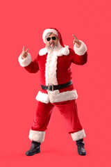 Cool Santa Claus in sunglasses on red background