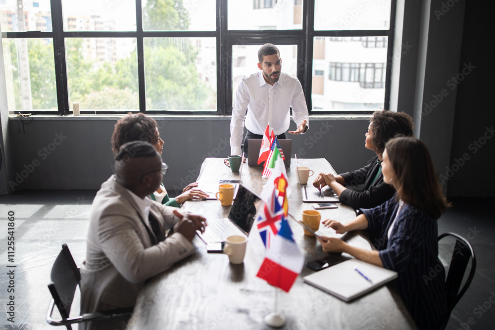 Poster diverse professionals engage in a collaborative meeting around a conference table, discussing strate