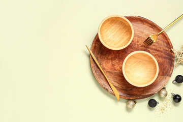 Beautiful table setting with Christmas balls on green background