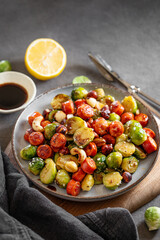 Brussels sprouts with chorizo ​​sausages, nuts and sesame seeds. Concept nutritious dish in a plate on a wooden board