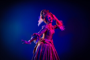 Photo of dreamy positive marie antoinette wear rich dress smiling dancing empty space isolated blue...