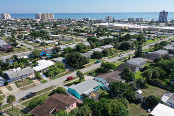 Aerial looking east toward the Atlantic Ocean over Daytona Beach neighborhoods and beachfront condos and hotels.