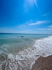 Fototapeta premium Serene beach day with clear blue skies and gentle waves. Porto Sant'Elpidio, Italy.