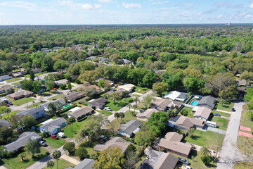 Aerial view of Ormond Beach, Florida suburban neighborhood houses and trees.	