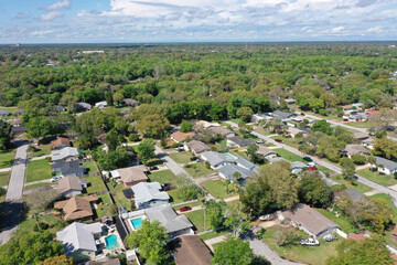 Aerial view of Ormond Beach, Florida suburban neighborhood houses and trees.	