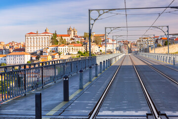 Dom Luis I Bridge in Porto, Portugal, featuring tram tracks and overlooking the historic cityscape