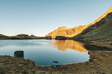 alpine landscape of fagaras mountains. balea lake of romania in autumn. sunny weather with clouds...