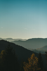 Fototapeta premium Sunsetting With Mountain Silhouette Shape. Big Beautiful Sunset Cloud Under The Mountains In A Haze.