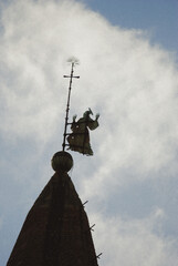 Weather vane of catholic saint in Arezzo, Italy.