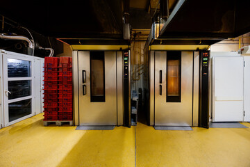 Modern bakery. Industrial ovens for baking bread, loafs, cakes and cookies