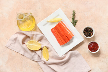 Plate with tasty crab sticks and different spices on beige background © Pixel-Shot