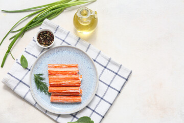 Plate with tasty crab sticks, dill and bowl of peppercorns on white background © Pixel-Shot