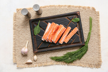Wooden board with tasty crab sticks, spinach leaves and dill on white background © Pixel-Shot