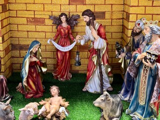 Christmas nativity scene with family. Christmas Manger scene with figurines including Jesus, Mary, Joseph, sheep and magi.
