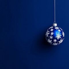 Blue christmas ornament with white snowflakes on dark blue background