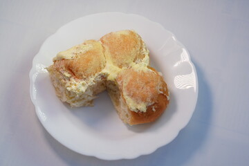 Bread rolls spread with butter and sugar